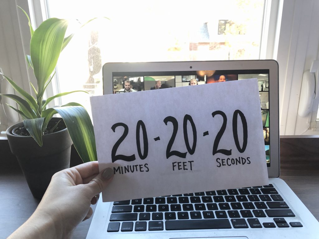 an open computer with a piece of paper in front of it that reads "20 minutes- 20 feet- for 20 seconds."
