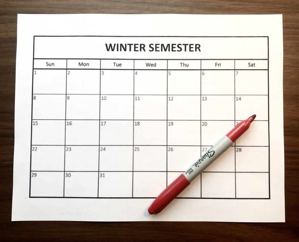 photo of a calendar that says winter semester with a red marker on top of it 