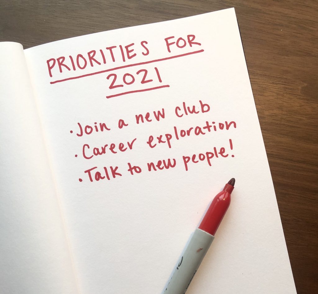 image of a notebook that reads priorities for 2021: Join a new club, career exploration, talk to new people!