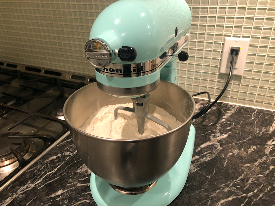 dry ingredients mixing in a blue KitchenAid mixer