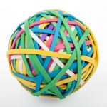 Tangled ball of colourful elastic bands