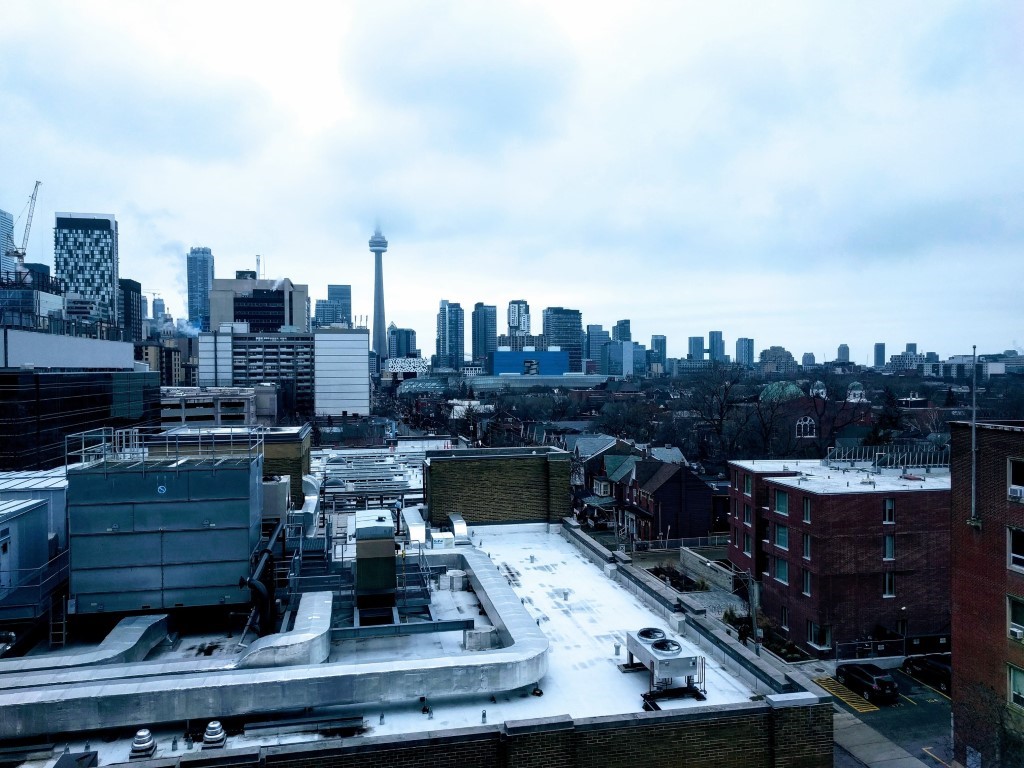 An outside view of Toronto and the CN Tower covered with snow from the Dalla Lana School of Public Health. 