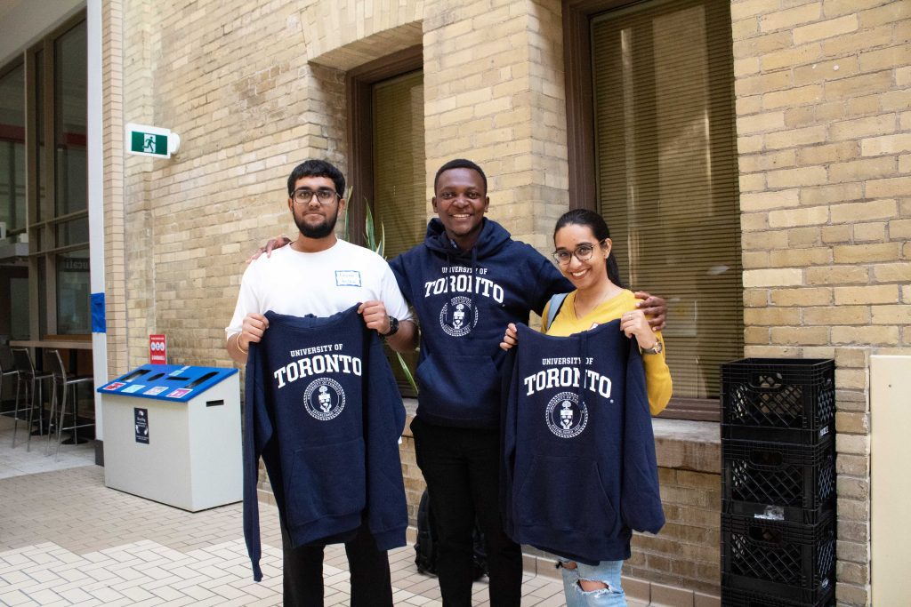 students holding U of T sweaters