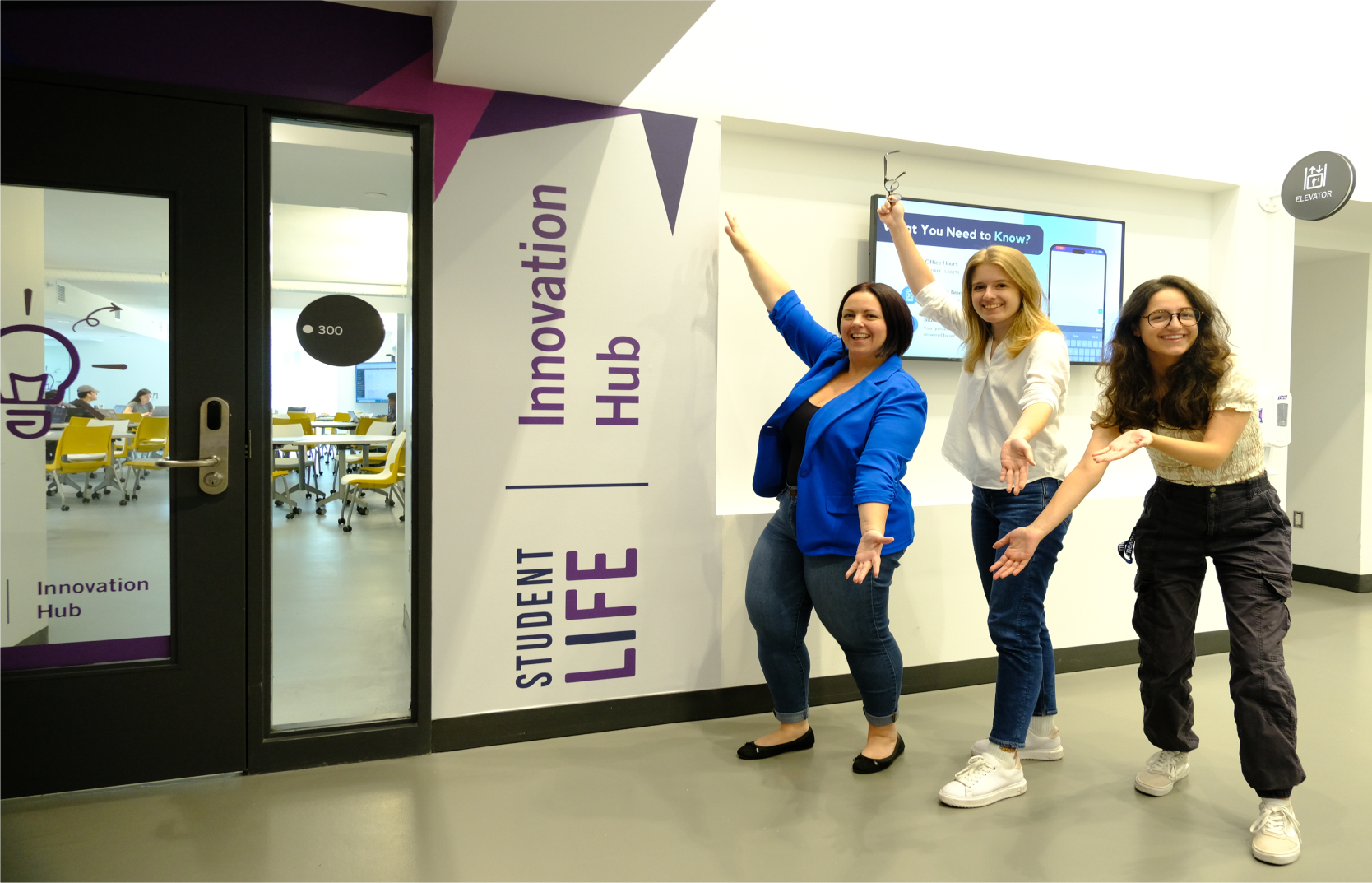 Project manager and project leaders posing in front of the Innovation Hub Space Entrance