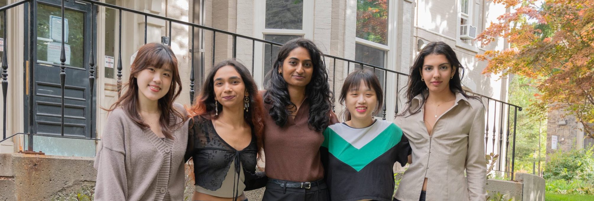 A photo of Reception experience at health & wellness Team, featuring five members standing outdoors, smiling at the camera.