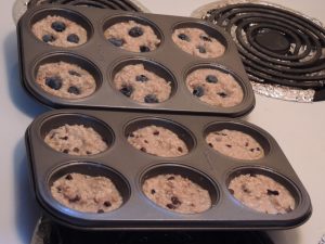 12 muffins sitting on a baking tray.