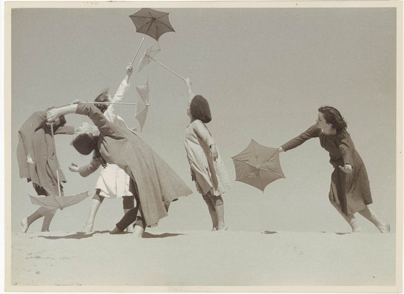 Photo of women dancing with umbrellas
