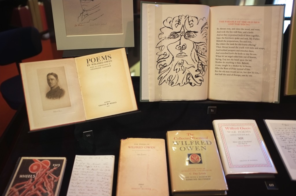 several books of the poems of Wilfrid Owen are displayed. One is open to show a picture of him while another shoes a strange line drawing that kind of looks like a lion and a person at the same time.