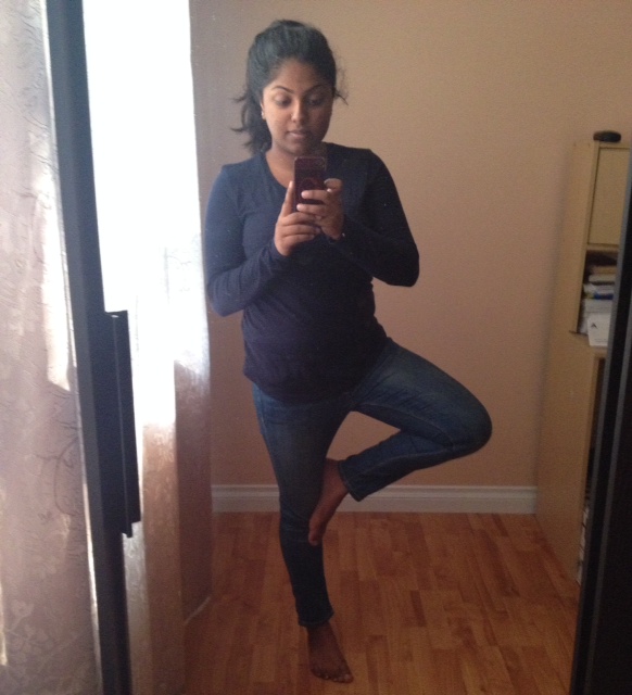 Picture of api doing tree pose with one leg bent and resting against her shin.
