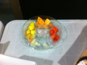 A fruit tray on a table, with cantaloupe, pineapple, watermelon, melon, and strawberries. It looks like it hasn't been touched.
