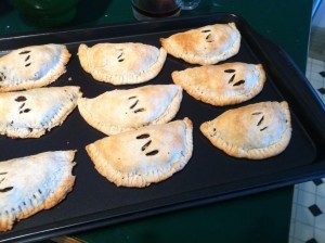 A cookie sheet with nine golden pastry pockets with the letter Z cut into each one