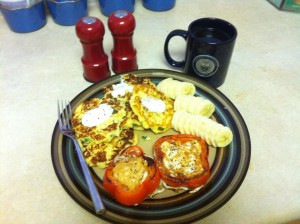 A pile of potato pancakes, sliced banana coins, and two rings of red pepper with fried eggs in the middle