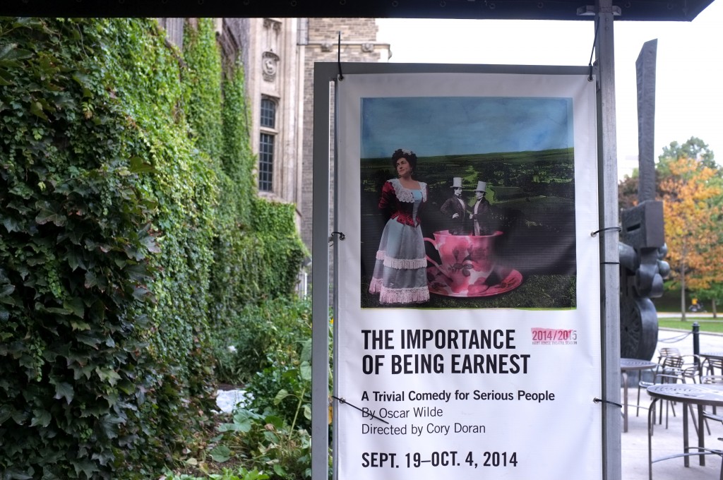 photo showing the poster for the importance of being earnest outside of hart house theatre. The poster has the name, a picture, and the show dates. 