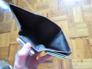 My wallet open in my hand, with no money whatsoever to be found inside