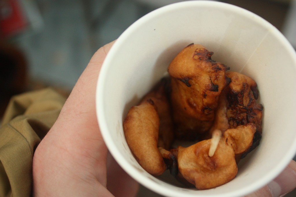 This image shows deep-fried banana in a paper cup.