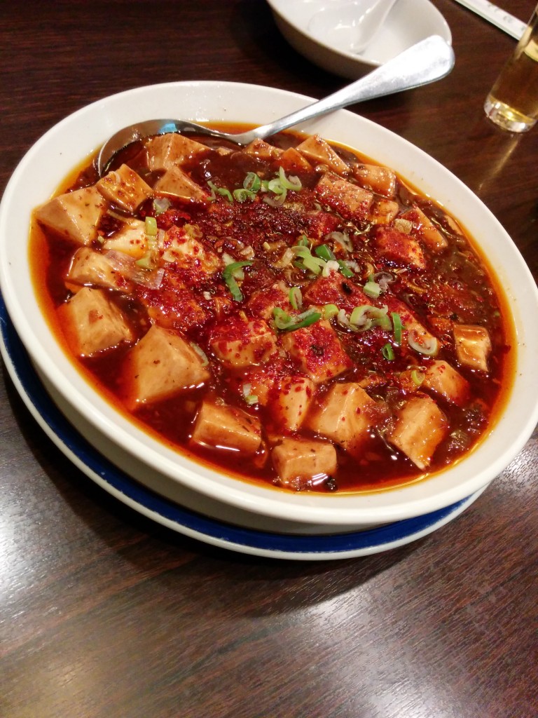 This image shows a bowl of tofu in sauce. This particular variety is  known as 'mapo tofu.'