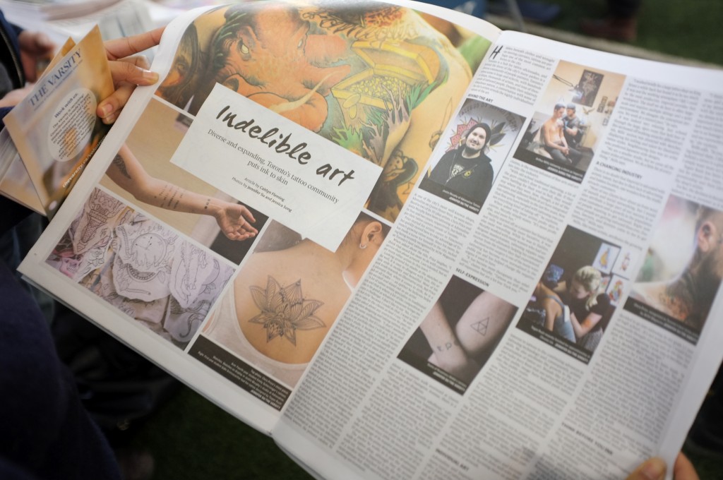 a picture of the inside of the varsity newspaper showing the article "the human canvas" which shows different tattoos. The images are accompanied by blocks of text that can't be read at this distance