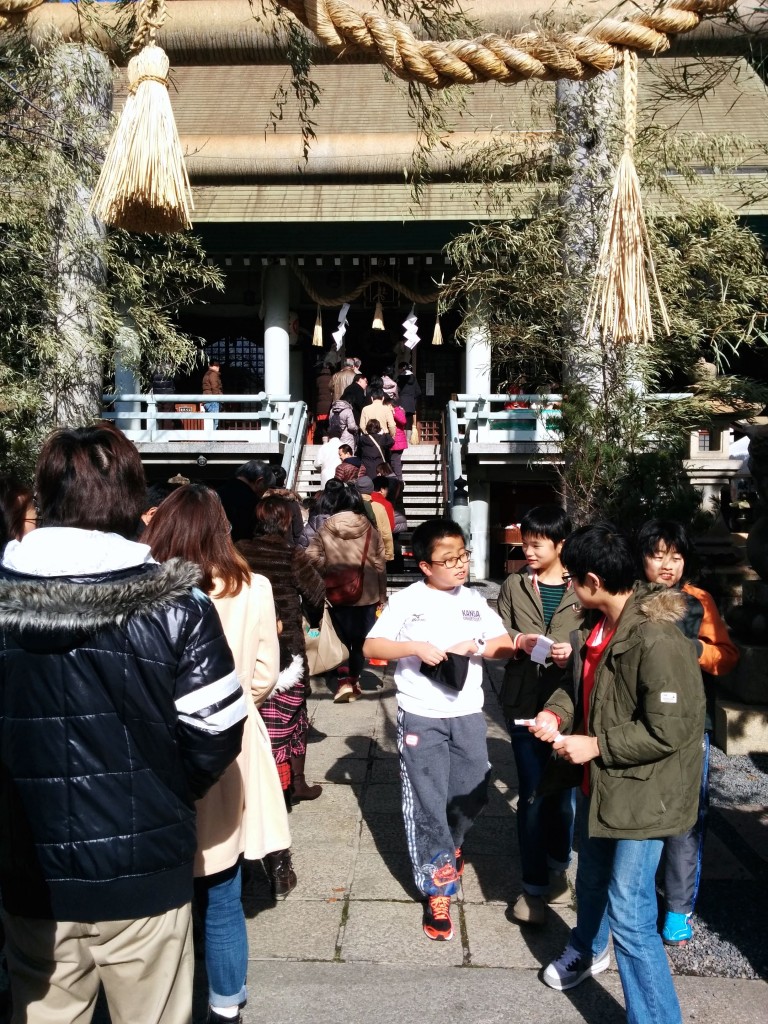 This image shows people queueing at a shrine. 