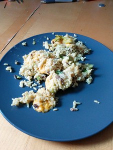 A picture of rice, stemmed broccoli, and a lot of cheese.  