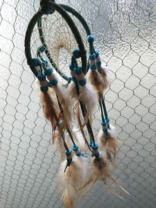 A double dream-catcher with many beautiful feathers