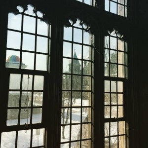 Looking out a window from Hart House, towards the towers of the main UC building