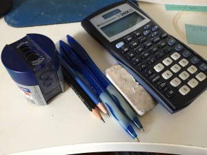 a pencil sharpener, two pencils, two pens, an eraser, and a non-graphing calculator