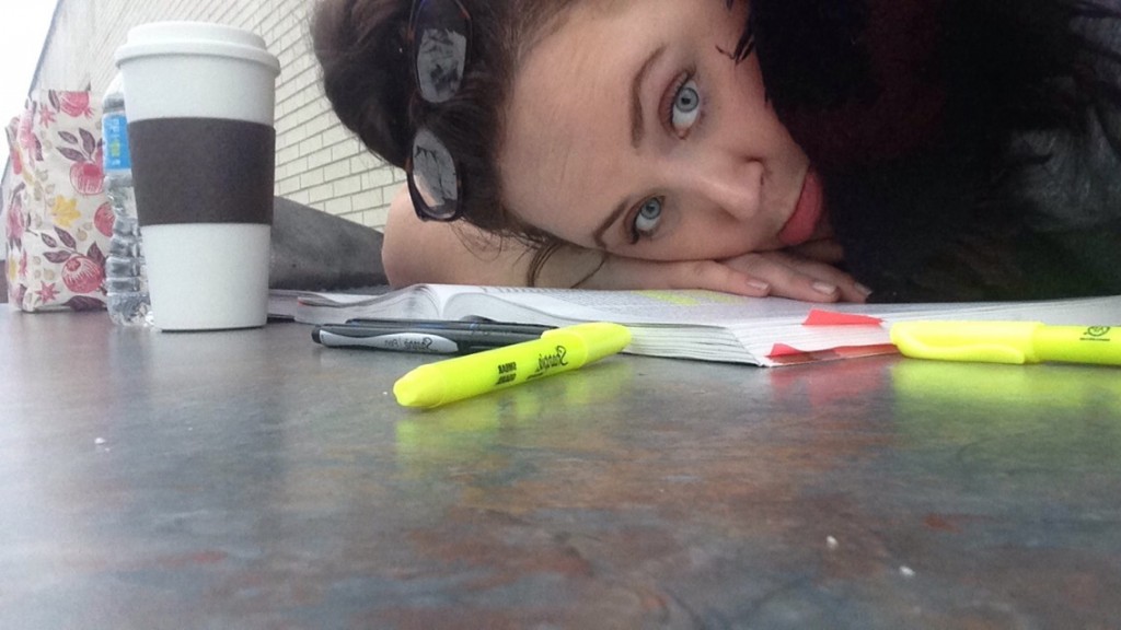 Photo of me with my head down on the desk , surrounded by homework, looking in despair 