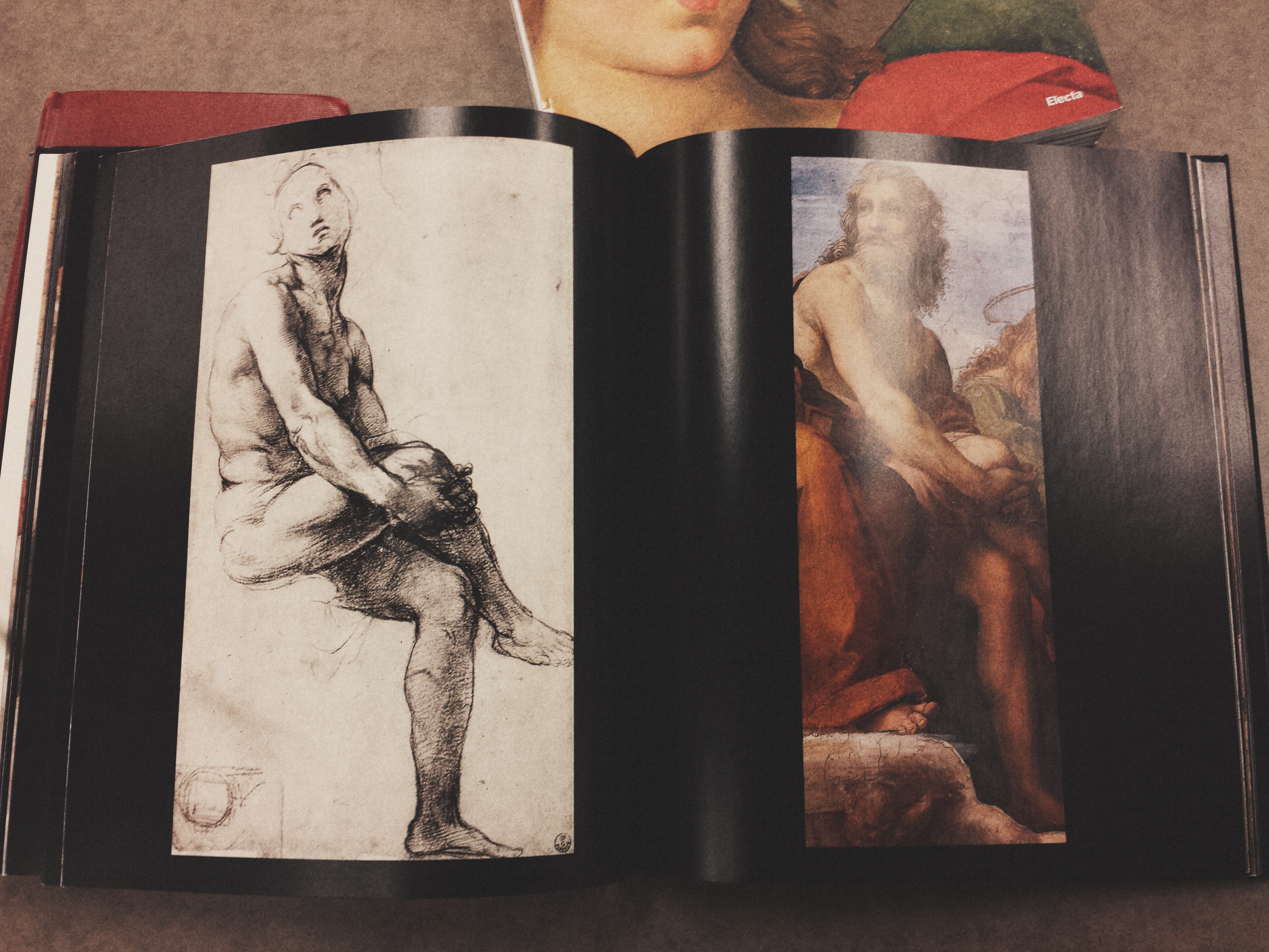 An art book I found in the Robarts stacks about Raphael's works. Flipped to a page of a character study, comparing his rough sketch and the final product of one of his paintings.
