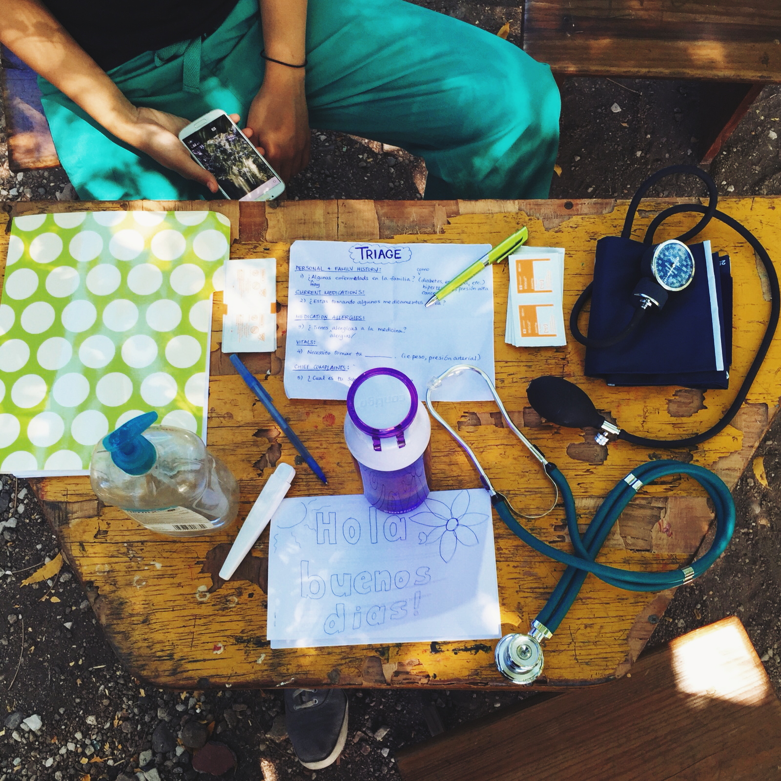 Our triage table is a tiny little yellow wooden table. On it lies hand sanitizer, a blood pressure cuff, a stethoscope, alcohol swabs, water bottles, pens, and a folder where we hold our forms and translation booklets.