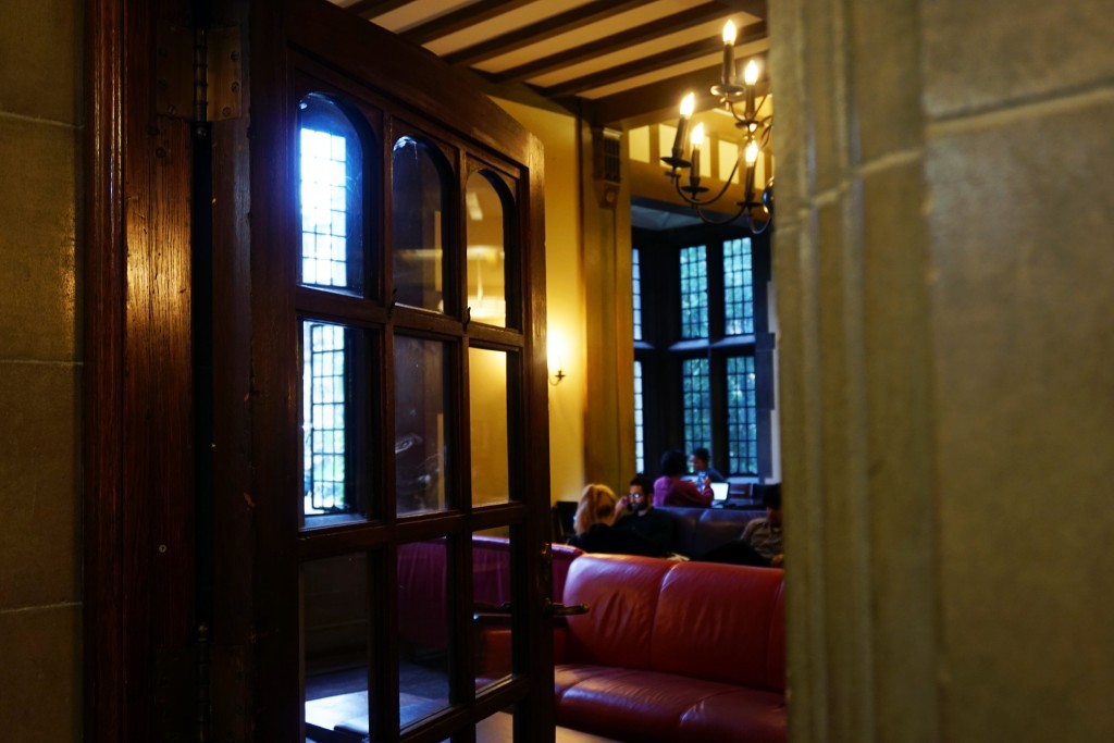 photo taken through a doorway of people sitting in the reading room 