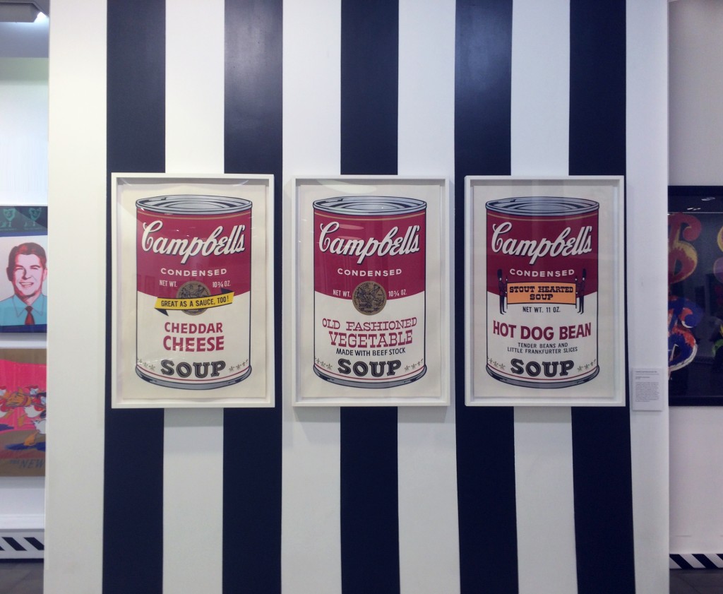 three of Warhol's iconic Campbell's Soup Cans