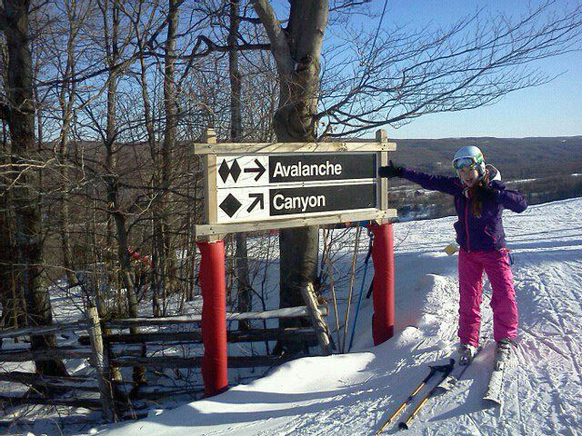 Photo of: Me giving a mitten-hand “thumbs up” over my excitement to be skiing what is said to be the steepest groomed run in Ontario!