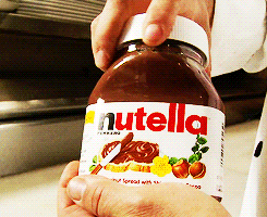 a spoon dipping temptingly into a jar of nutella