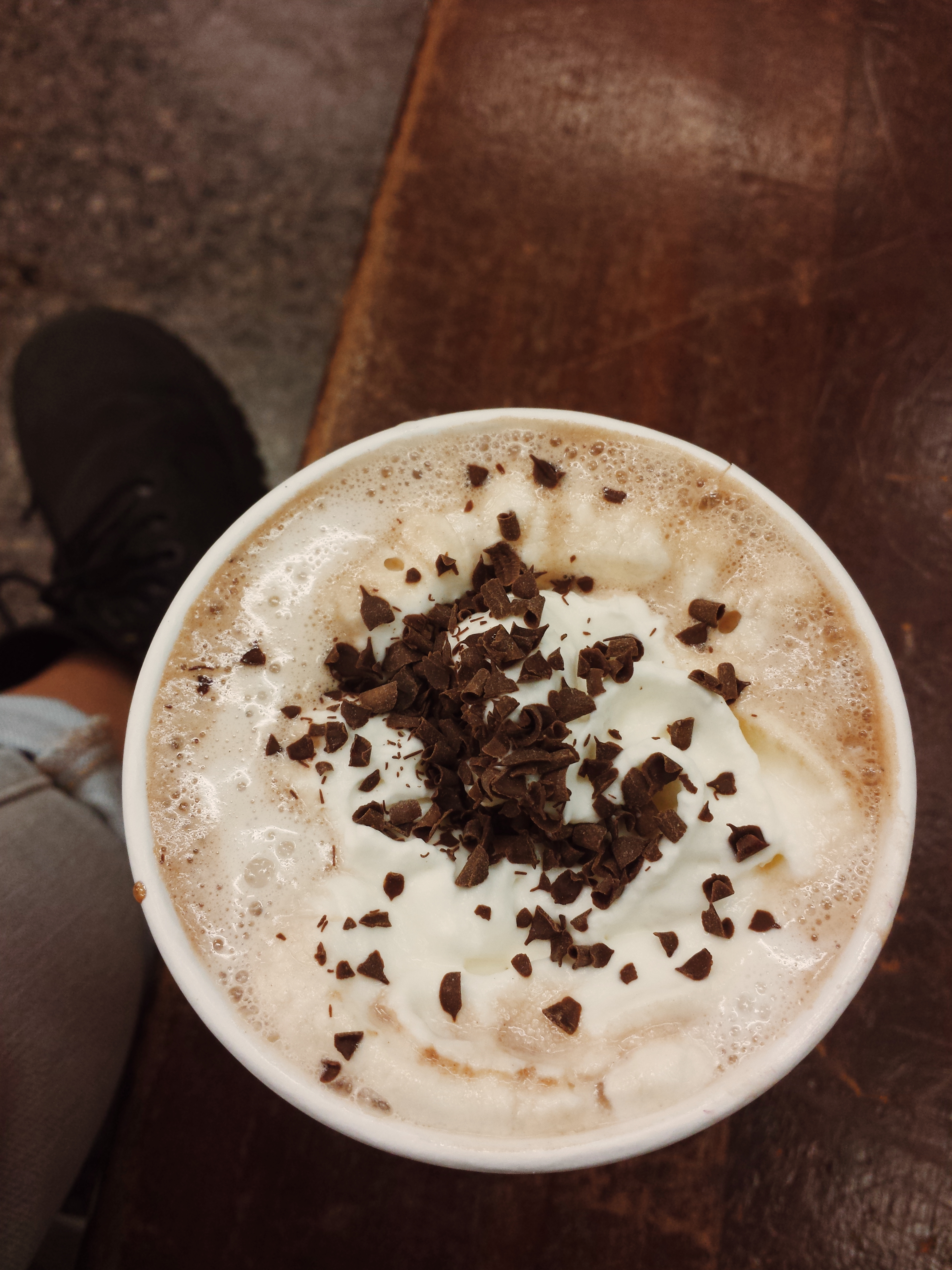 Close-up of a Starbucks Peppermint Mocha with whipped cream and chocolate shavings.