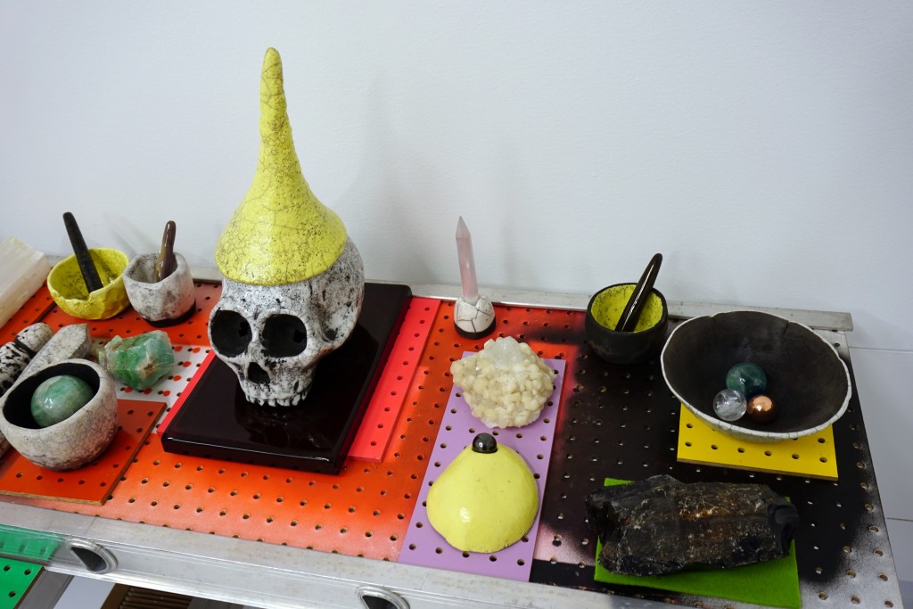 A bright and unsettling assortment of skulls, rock bowls, and crystals