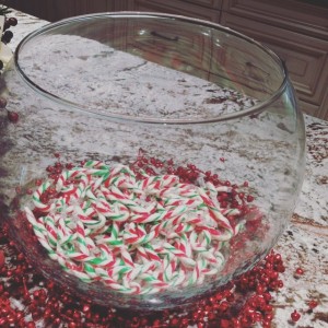 A glass bowl of candy canes.