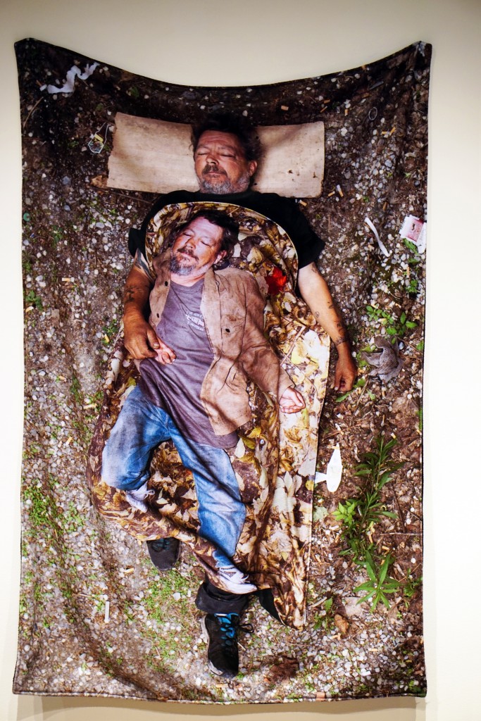 a photo printed onto a blanket of a man wearing a blanket with a photo of himself on it