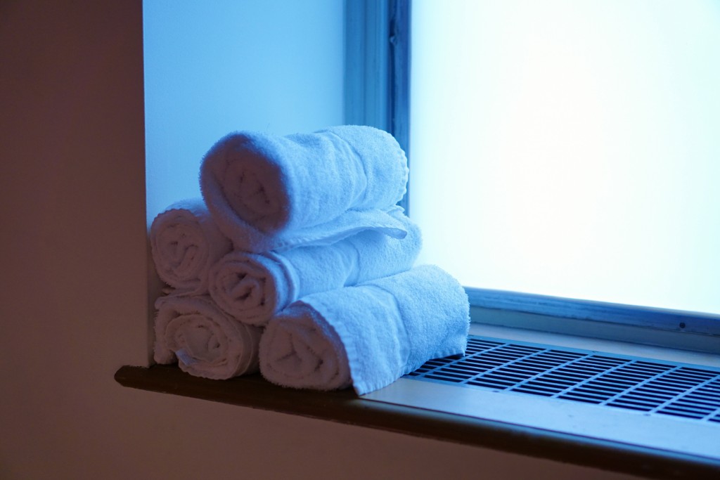 a stack of towels against a window