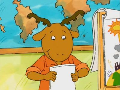 Pictured: George from PBS' Arthur smiling while giving a presentation.
