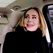 A GIF of Adele rolling her eyes and looking weirded out.
