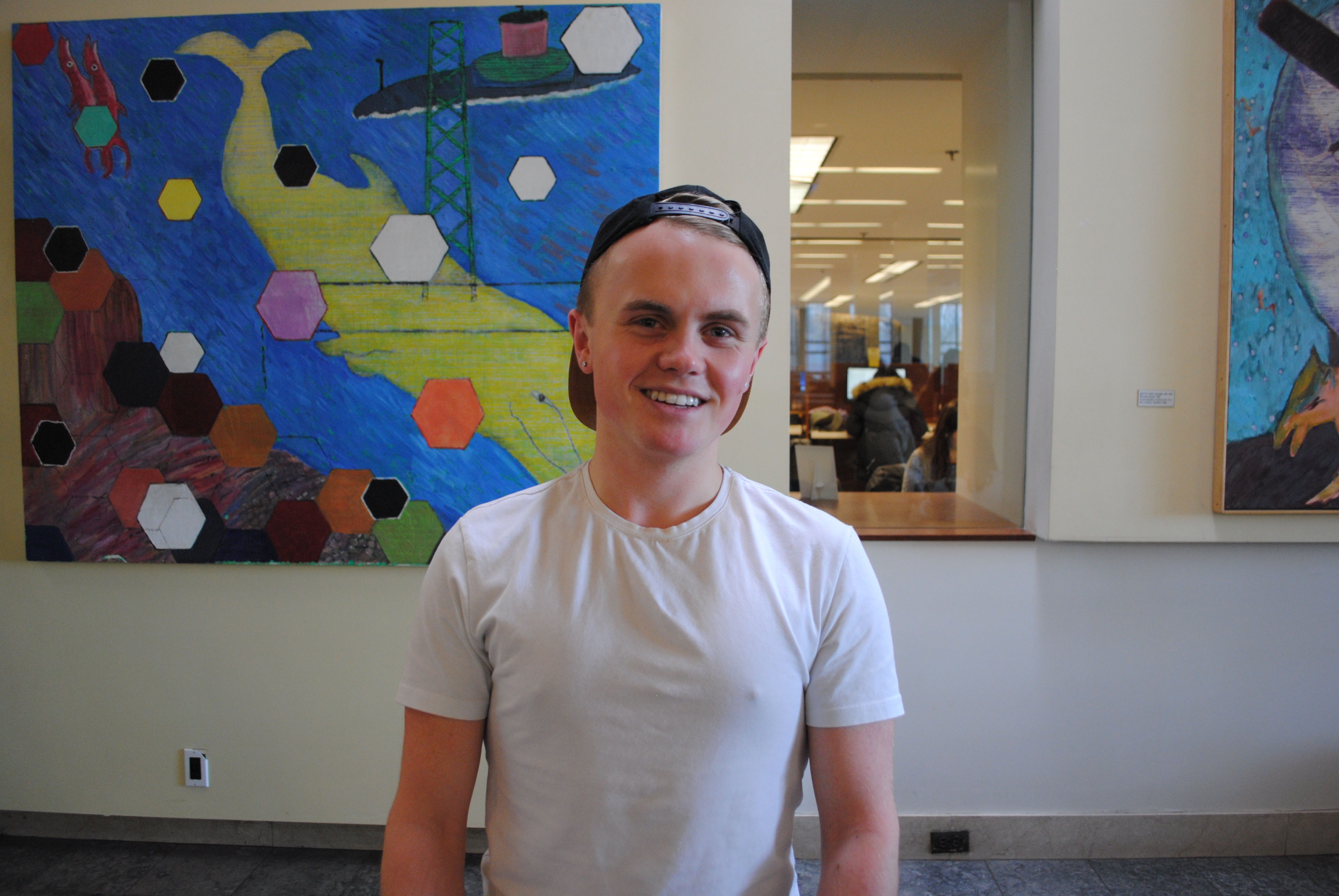 Robbie in front of the colourful murals in the Gerstein lobby.