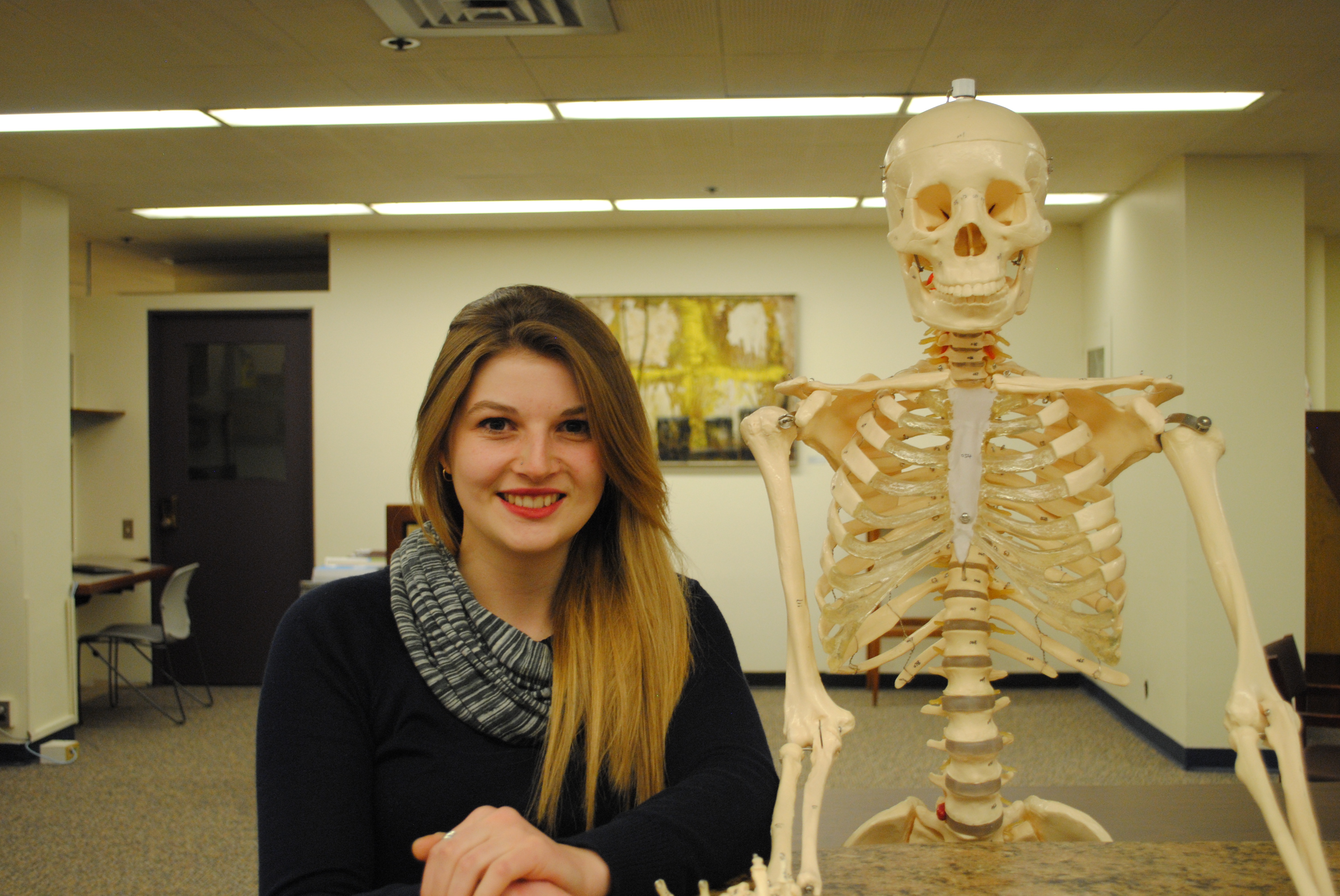 Ros next to the skeleton model in Gerstein Library.