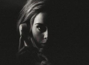 Adele holding a phone