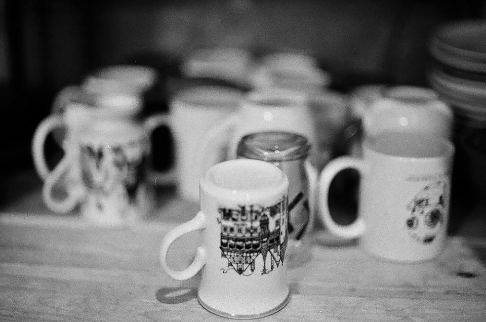 Ceramic mugs on a shelf in Caffiends