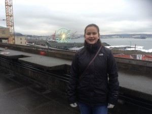 A photograph of Liana posing in front of a ferris wheel