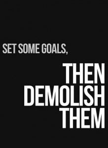 White and grey text on a black background reads "Set some goals, then demolish them."