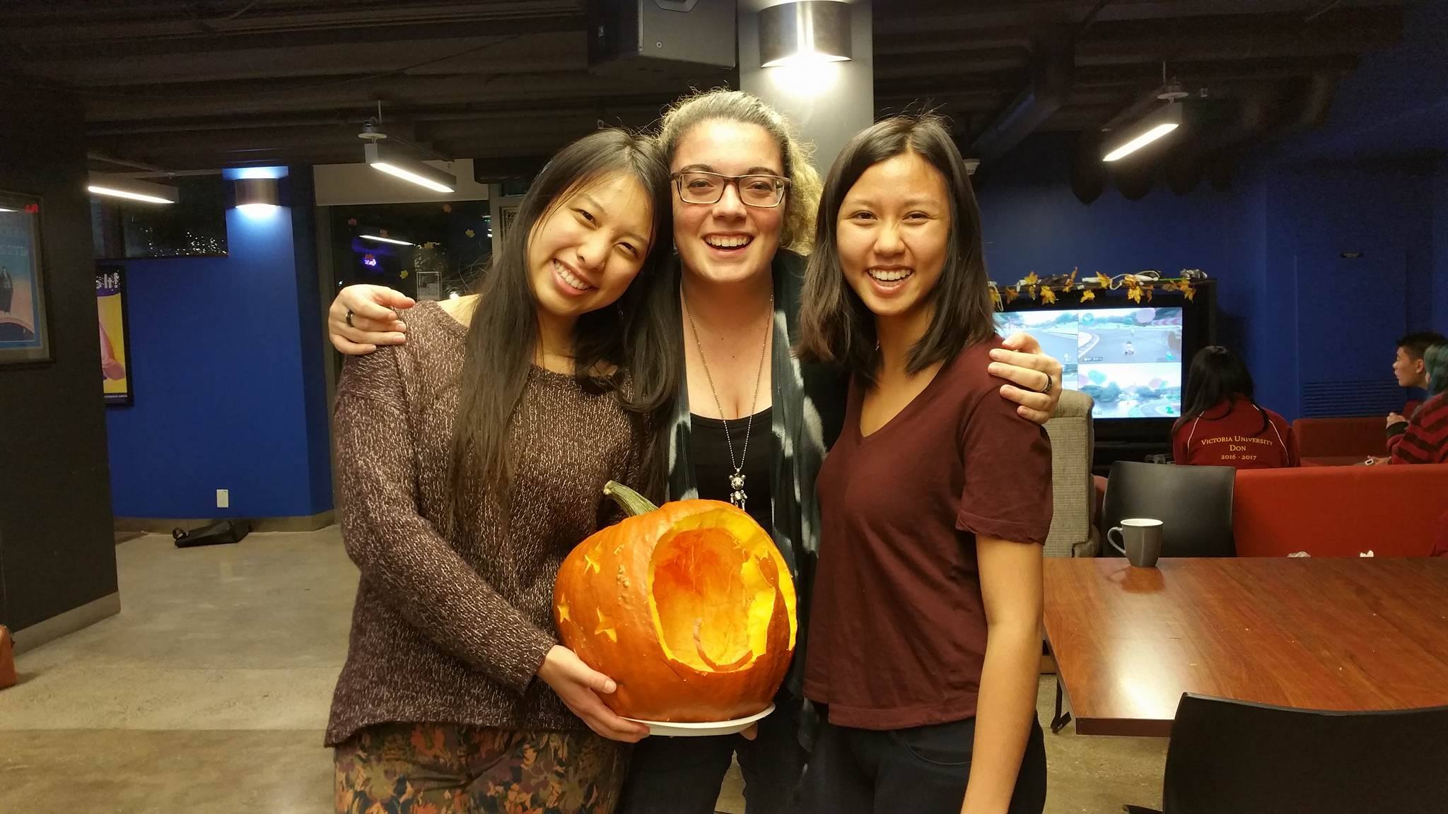 Three girls with pumpkin