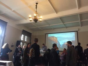 a photo of people networking in between breakout groups at the conference
