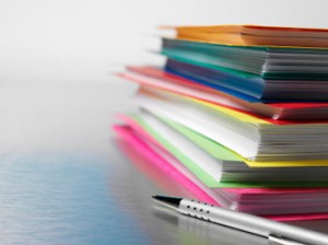 Picture of stack of journals and a pen