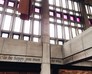 ALT="A building with the phrase [To be happy you must be wise] carved into stone"